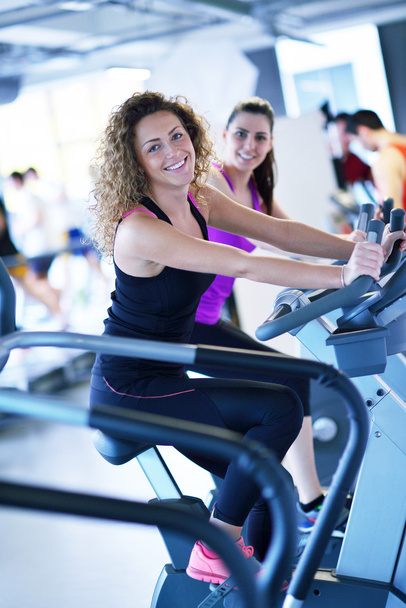 Women working out at fitness cycle - Foto, imagen