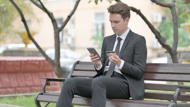 Businessman Shopping Online while Sitting on Bench - Photo, Image