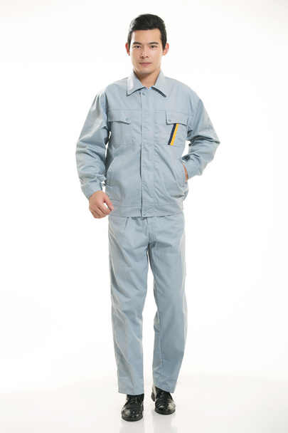 The young engineer various occupation clothing standing in front of a white background - Фото, зображення