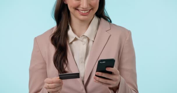 Credit card, phone and hands of business woman online shopping in studio isolated on blue background. Smartphone, ecommerce and happy professional banking on fintech, payment and finance transaction. - Footage, Video