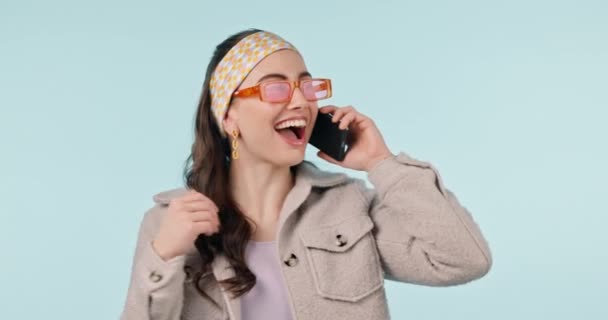 Fashion, news and woman with wow phone call in studio for sale, promotion or sign up deal on blue background. Smartphone, surprise and female winner excited for giveaway, prize or membership discount. - Footage, Video