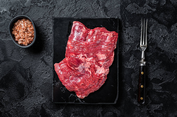 Skirt or Machete beef steak, raw meat ready for cooking. Black background. Top view. - Fotoğraf, Görsel
