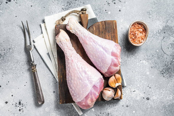 Raw turkey legs, Poultry meat. Gray background. Top view. - Fotoğraf, Görsel