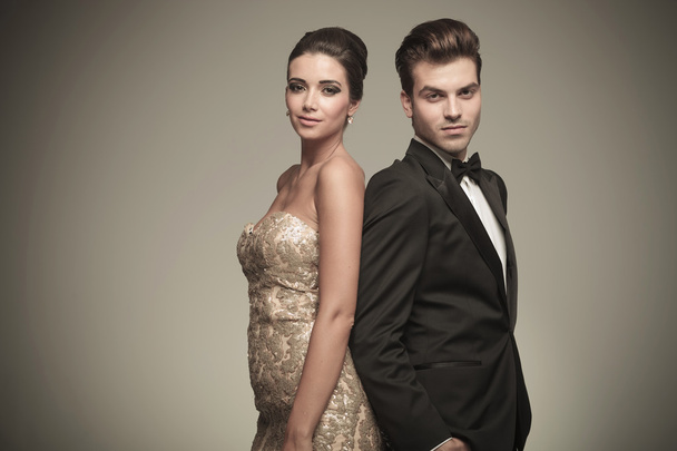 Elegant man and woman standing back to back - Photo, Image