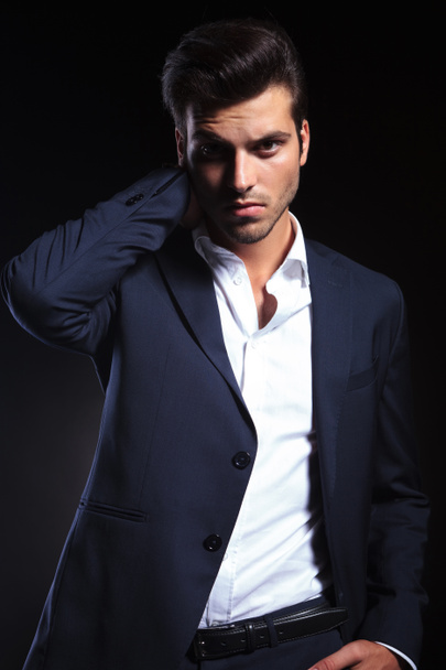 Handsome young business man holding one hand to his neck. - Photo, Image