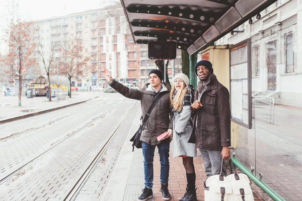 τρία άτομα νέοι πολυεθνικοί φίλοι ζητώντας ταξί - Φωτογραφία, εικόνα