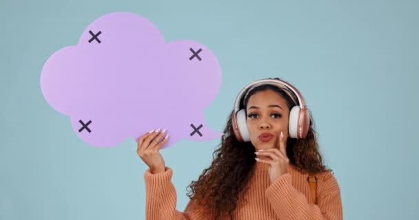 Speech bubble, thinking and woman with headphones in studio for solution idea, music or social media.Young person with announcement, question and streaming faq on a blue background, tracking markers. - Footage, Video