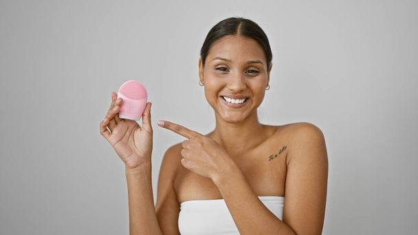 Young latin woman smiling confident holding robot massager at street - Foto, Imagem