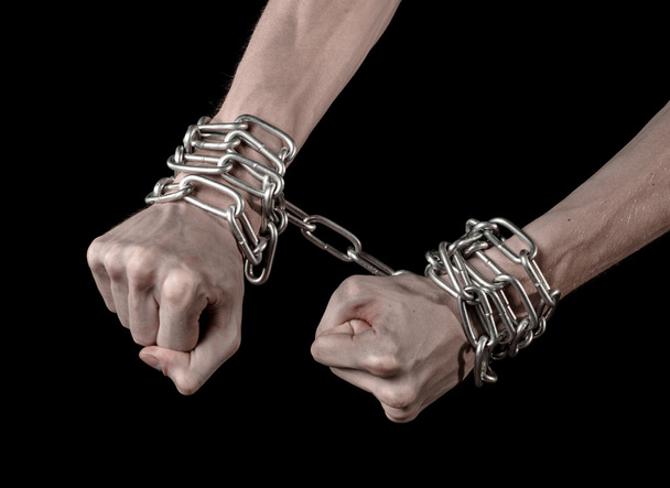 Hands tied chain, kidnapping, dependence, loneliness, social problem, halloween theme, killer, crazy, freedom black background - Foto, Bild