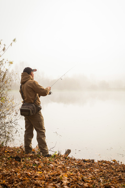Fisherman on the autumn background. - Zdjęcie, obraz