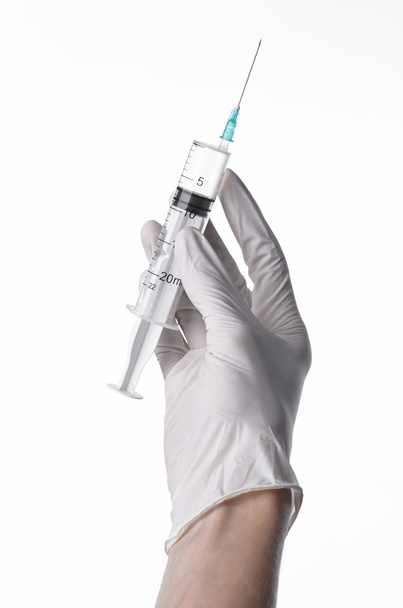 Doctor's hand holding a syringe, white-gloved hand, a large syringe, medical issue, the doctor makes an injection, white background, isolated, white gloves doctor - Photo, Image