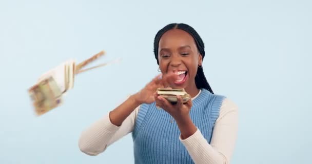 Happy black woman, money and financial freedom for winning, lottery or savings against a studio background. Excited African female person blowing cash, paper or bill in happiness or finance on mockup. - Séquence, vidéo