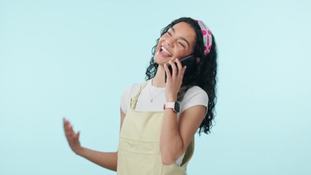 Woman, smile and phone call communication in studio for discussion, conversation and mobile contact on blue background. Happy model, smartphone and news of funny chat, social networking and talking. - Footage, Video