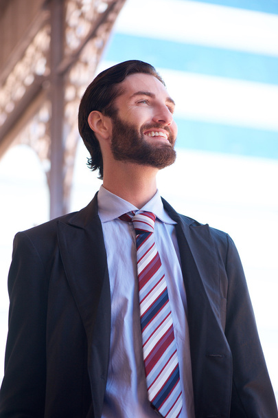 Smiling businessman standing outside in the city - Fotografie, Obrázek