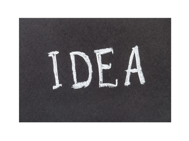 Inscription " idea" on a black sheet of paper - Zdjęcie, obraz