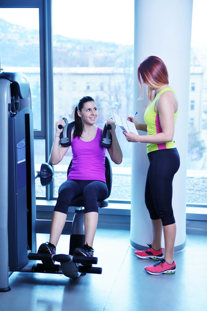 Woman exercising with her personal trainer - Photo, image