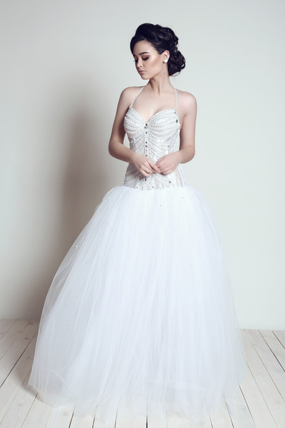 elegant bride with dark hair in luxurious wedding dress   - Fotografie, Obrázek