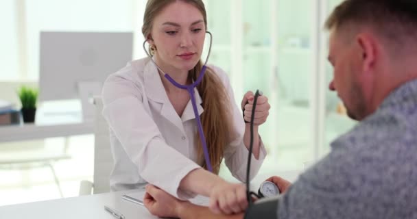 Doctor measuring blood pressure to man patient using tonometer closeup. Blood pressure measurement and hypertension - Footage, Video