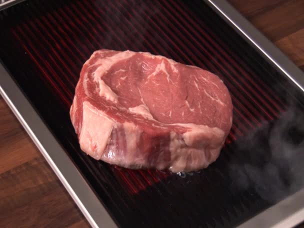 Turning beefsteak on an  grill - Záběry, video