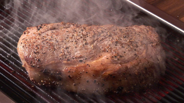 Grilling beef steak on grill - Footage, Video