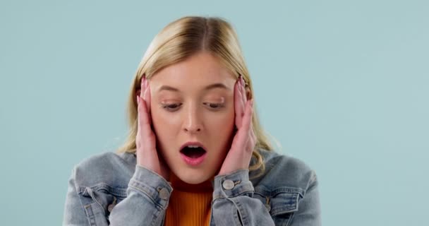 Surprise, face and woman with stress, anxiety and thinking of news, announcement and problem solving a mistake or crisis. Wow, confused and portrait of gen z girl on blue background with headache. - Footage, Video