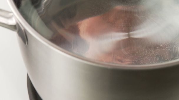 Pot of water being placed upon gas cooker - Materiał filmowy, wideo