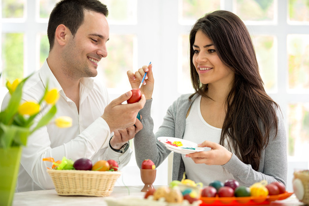 Young man and woman painting Easter eggs - Photo, image