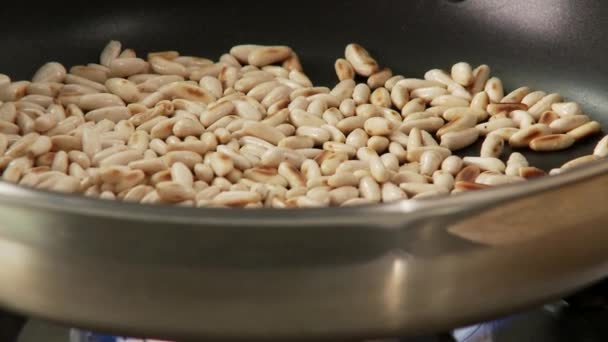 Pine nuts being roasted in a pan - Footage, Video