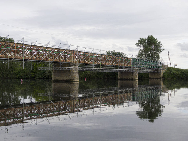 Scaffolding used for maintenance or restoration work on a small bridge over a large river the Cher - Photo, Image