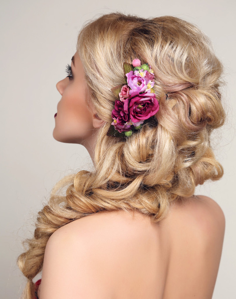 beautiful sensual woman with blond curly hair and flower's accessory   - Foto, afbeelding