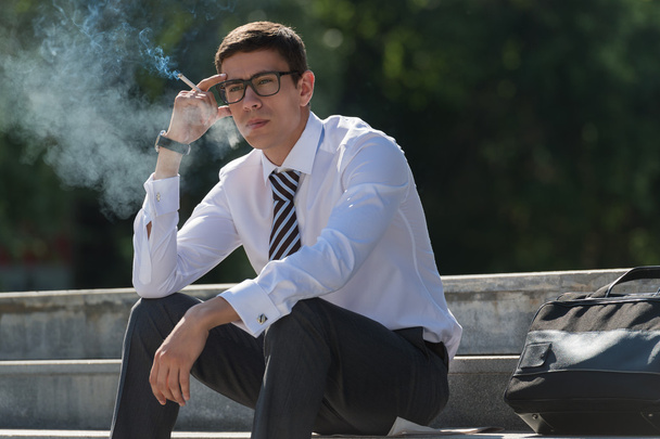 Well dressed businessman smoking - Фото, зображення