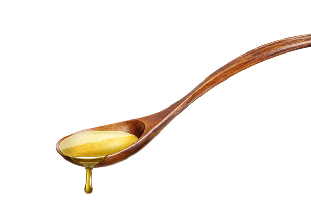 Wooden spoon with vegetable oil - Foto, Imagen