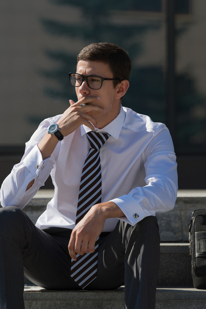 Well dressed businessman smoking - Фото, зображення