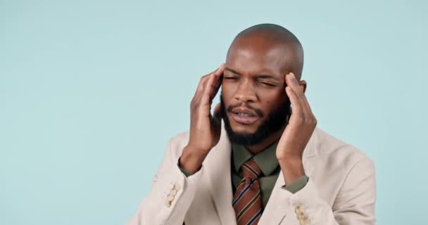 Headache, black man and face with pain and burnout in studio from corporate job and mental health. Businessman, person and stress with anxiety and brain fog from audit career on blue background. - Footage, Video
