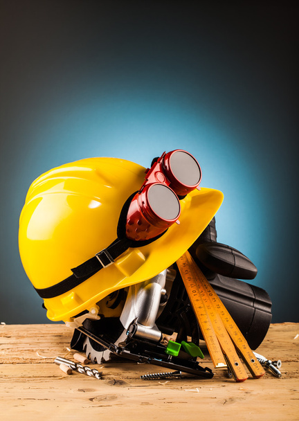 yellow helmet and wood mounting tools  - Φωτογραφία, εικόνα
