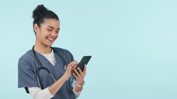 Happy woman, doctor and phone in studio, social media scroll and laughing at meme, post and mockup. Smile, smartphone and medical professional on mobile app for fun video streaming on blue background. - Footage, Video
