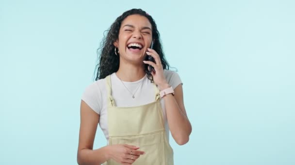Woman, laugh and phone call communication in studio for discussion, conversation and mobile contact on blue background. Happy model, smartphone and news of funny joke, social networking and talking. - Footage, Video