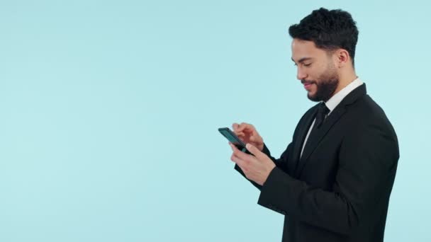 Happy businessman, phone and typing on mockup space in social media against a studio background. Male person or business employee smile for online chatting, texting or search on mobile smartphone app. - Footage, Video