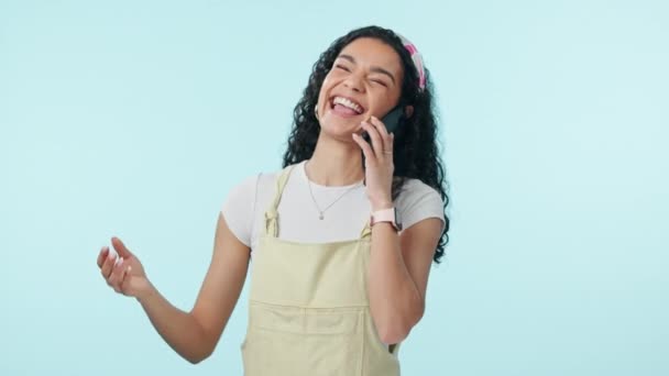 Woman, laugh and phone call in studio with smartphone for communication, conversation and mobile contact on blue background. Happy model, cellphone and talking about funny news, discussion and gossip. - Footage, Video