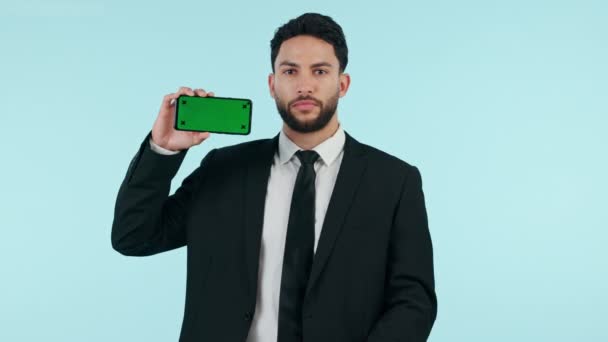 Business man, phone green screen and presentation, website sign up information and advertising in studio. Face of professional on mobile mockup, pointing you and tracking marker on a blue background. - Footage, Video