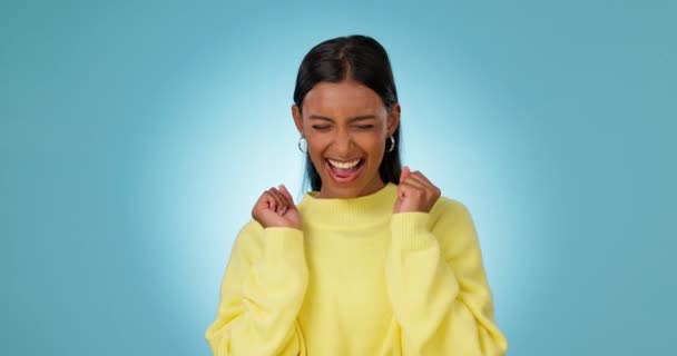 Dance, excited and woman in celebration of success, winning or promotion in studio isolated on a blue background mockup space. Happy, winner and person celebrate victory, lottery and goal achievement. - Footage, Video