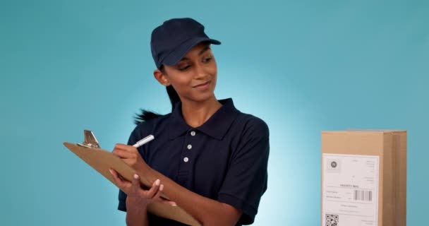 Happy woman, delivery and writing with thumbs up in logistics, shipping or inspection against a studio background. Portrait of female person with box, checklist or like emoji for courier service. - Footage, Video