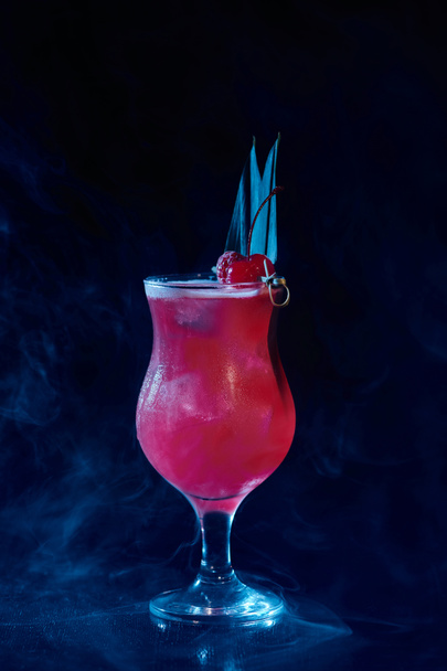 exotic singapore sling cocktail with raspberry garnishing on black smokey backdrop, concept - Photo, Image