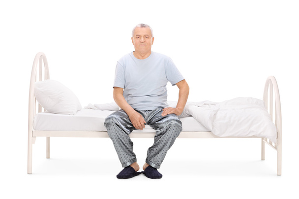 Senior man in pajamas on bed - Foto, imagen