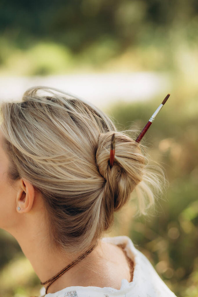 paint brushes in the artist's hair - Photo, Image