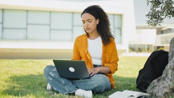Full-length video of a upset disappointment brazilian or hispanic curly haired girl, freelancer, sitting on the grass near the tree, with a closed laptop, feels anxious, frustrated, sadly looks away - Footage, Video