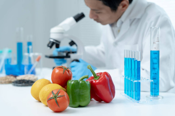 Scientist check chemical food residues in laboratory. Control experts inspect quality of fruits, vegetables. lab, hazards, ROHs, find prohibited substances, contaminate, Microscope, Microbiologist - Foto, immagini