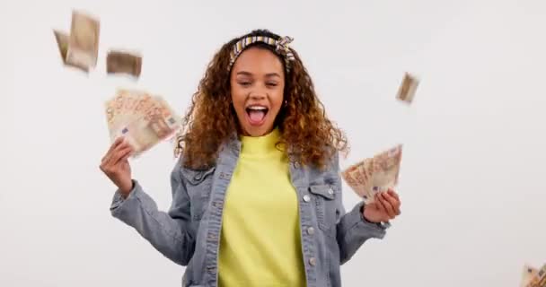 Woman, winner and money rain for success, winning and lottery, bonus or financial freedom on a white background. Excited face of african person dancing with cash in air, fan and competition in studio. - Séquence, vidéo