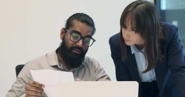 Indian businessman engages in a consultative conversation, providing guidance and insights to his Caucasian colleague. Their collaborative interaction exemplifies the exchange of expertise. - Footage, Video