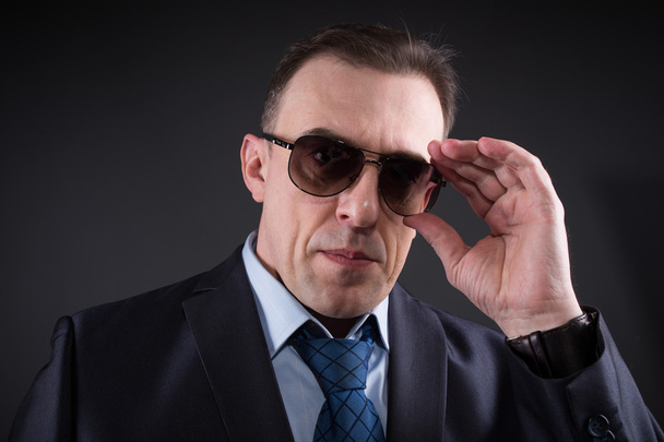 Confident businessman in sunglasses - Фото, зображення